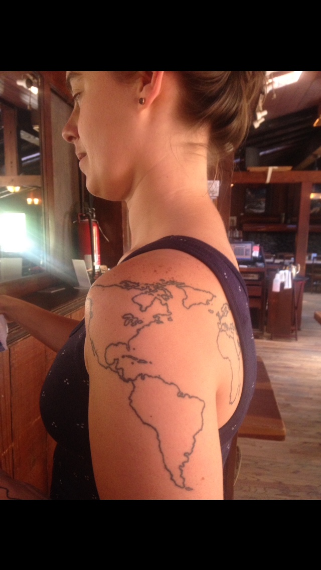 A waitress with a world map tattooed across her shoulder