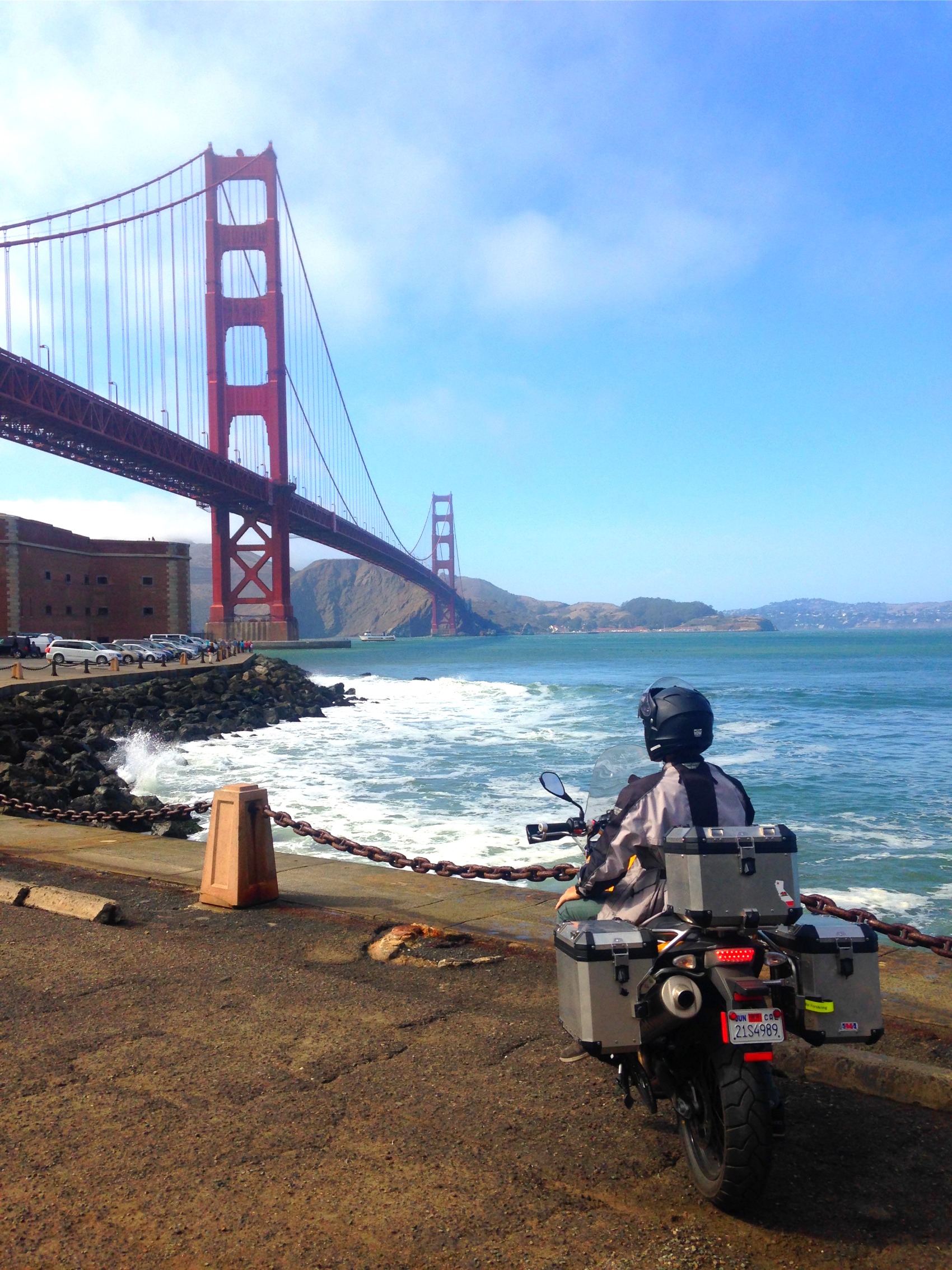 The loaded motorcycle on the sea wall under the Golden Gate Bridge