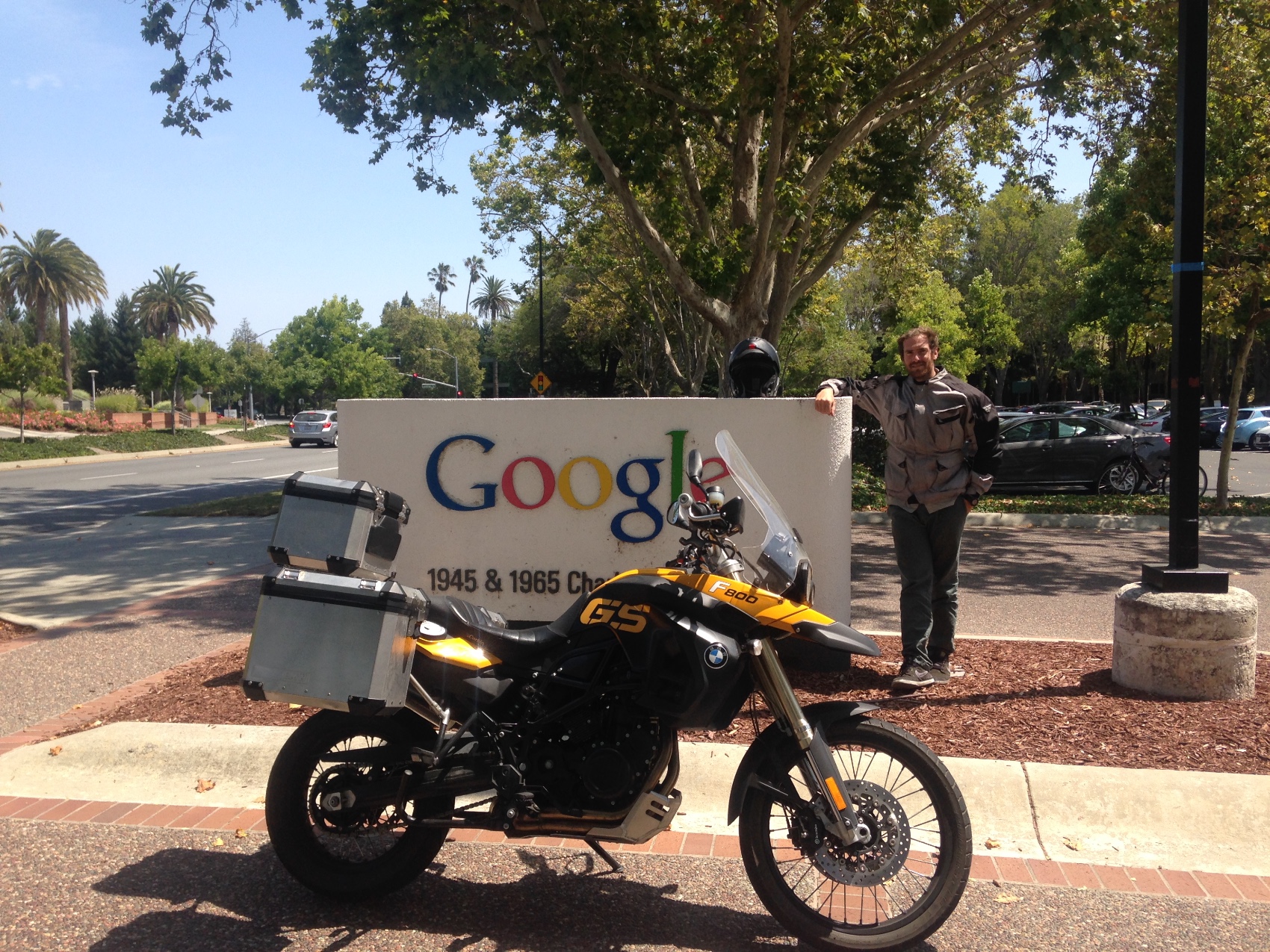 The motorcycle parked in front of the Google sign