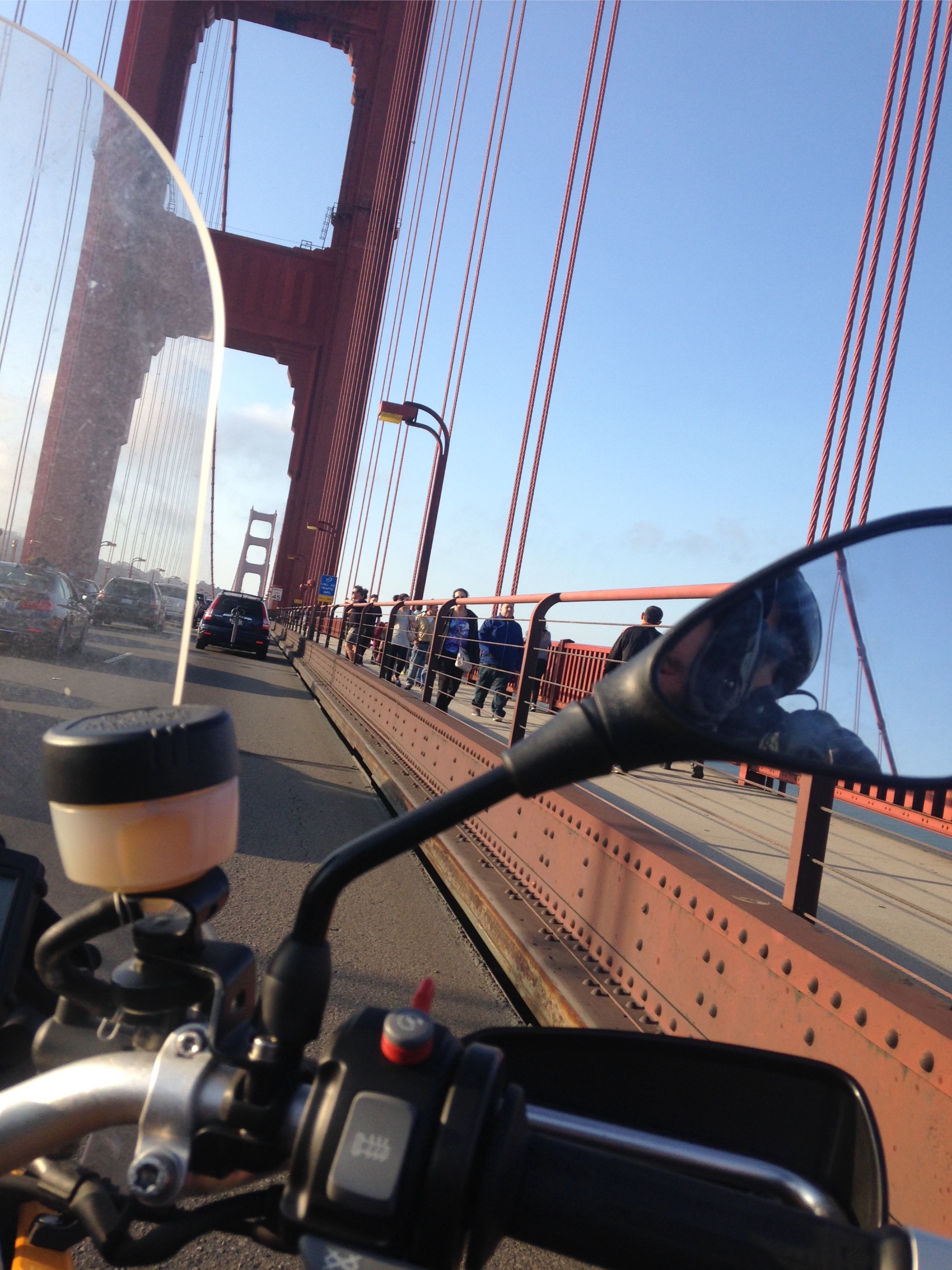 Riding across the Golden Gate Bridge seen over the handlebar