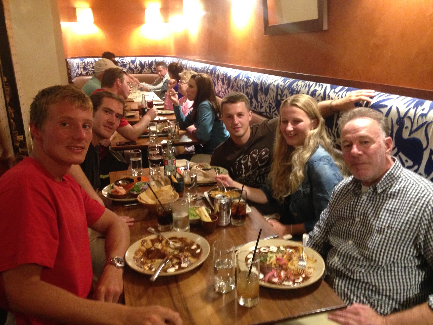 A long restaurant table full of young travellers