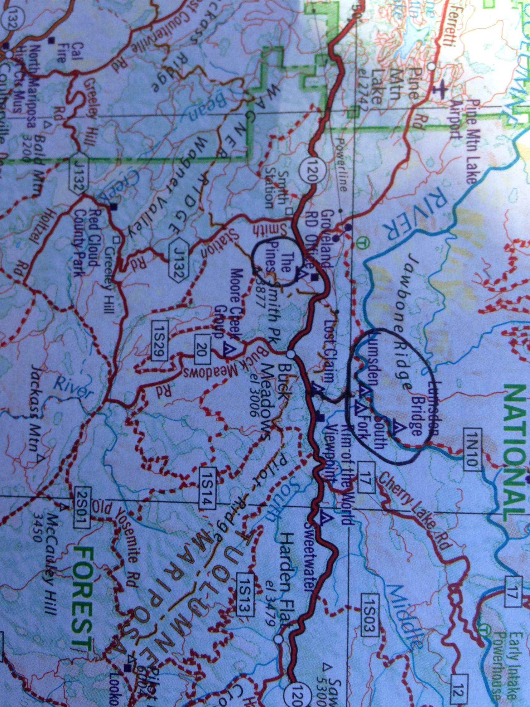 A paper national forest map with campgrounds circled in pencil