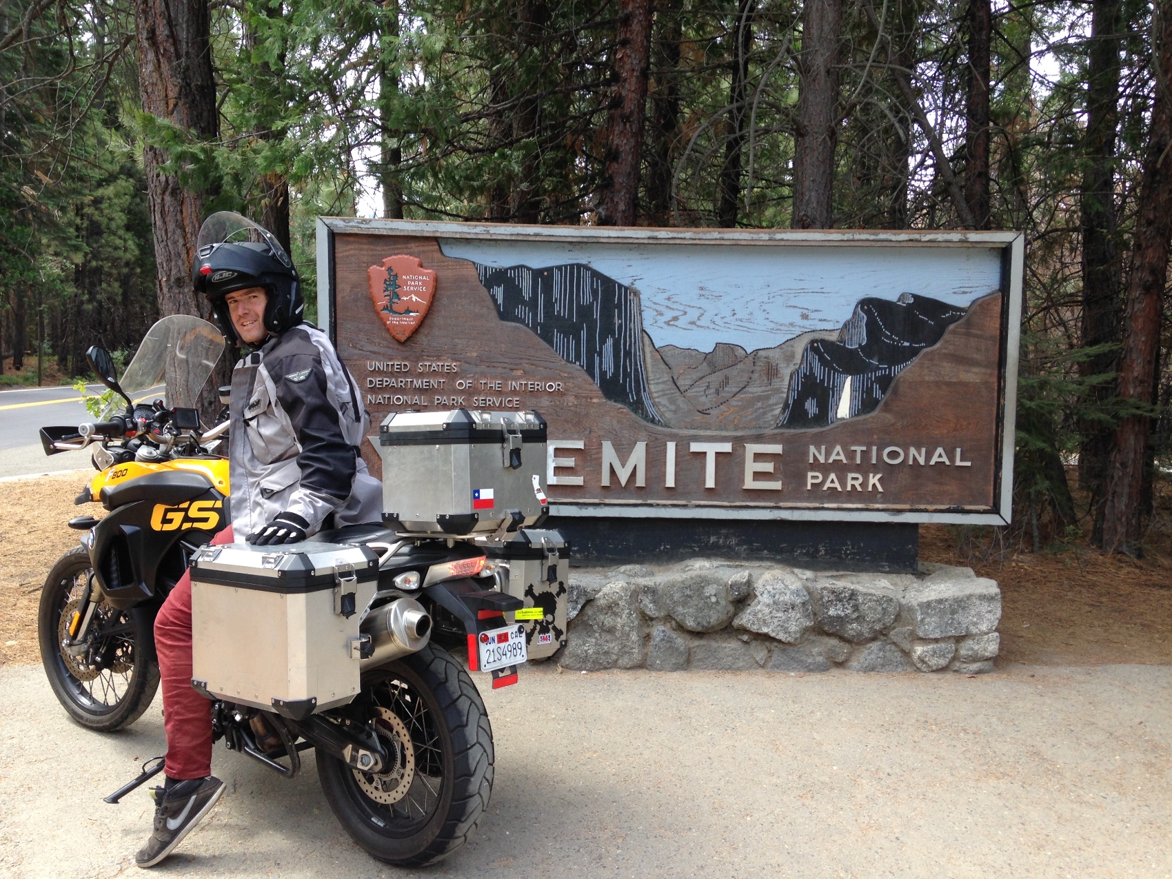 Rodrigo on the motorcycle at the Yosemite National Park entrance sign