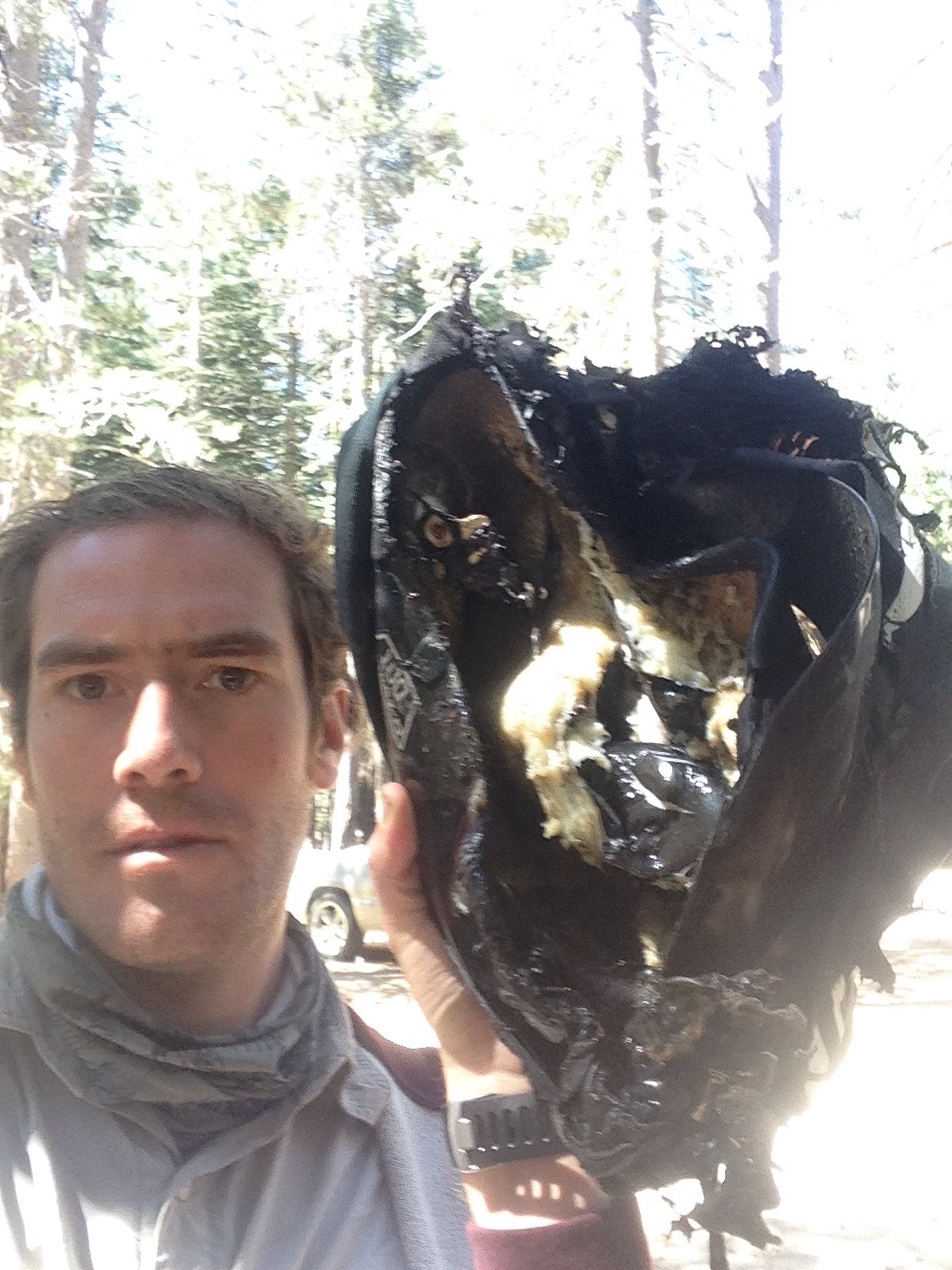Rodrigo holding up a completely melted motorcycle helmet