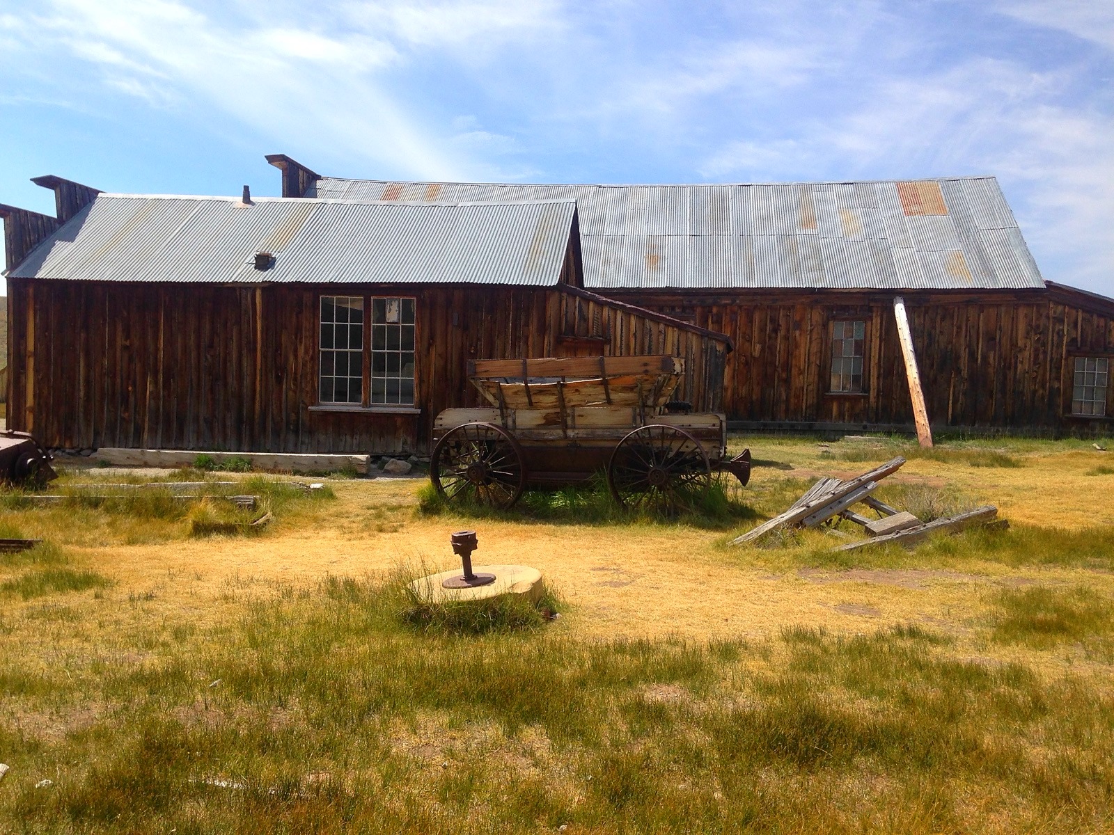 A wooden barn and a wagon at Bodie ghost town