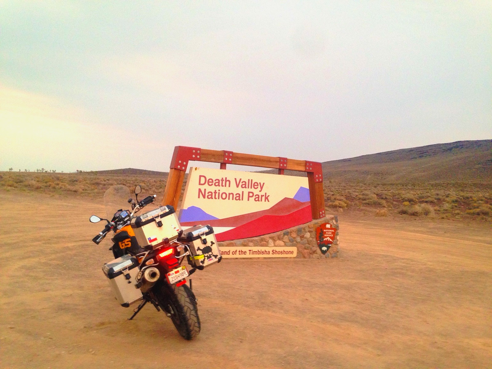 The motorcycle at the Death Valley National Park sign