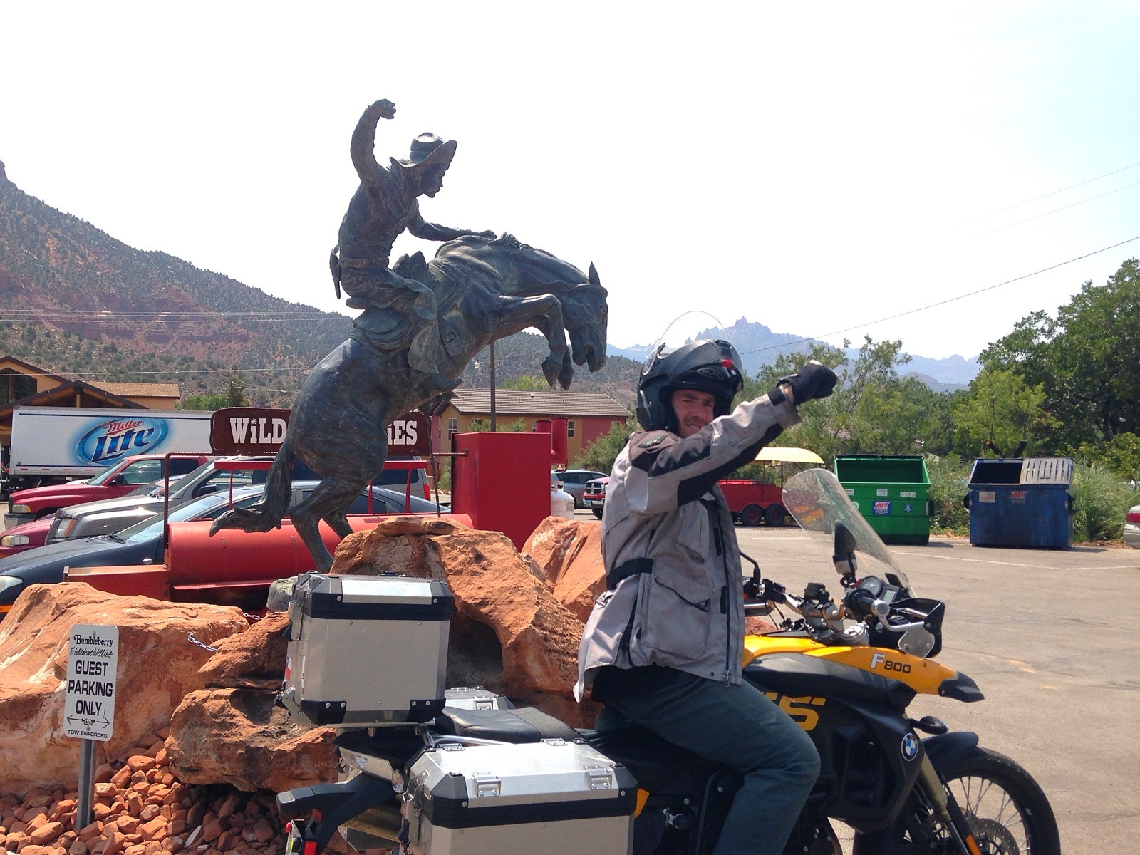 The motorcycle beside a bronze rodeo statue near Zion