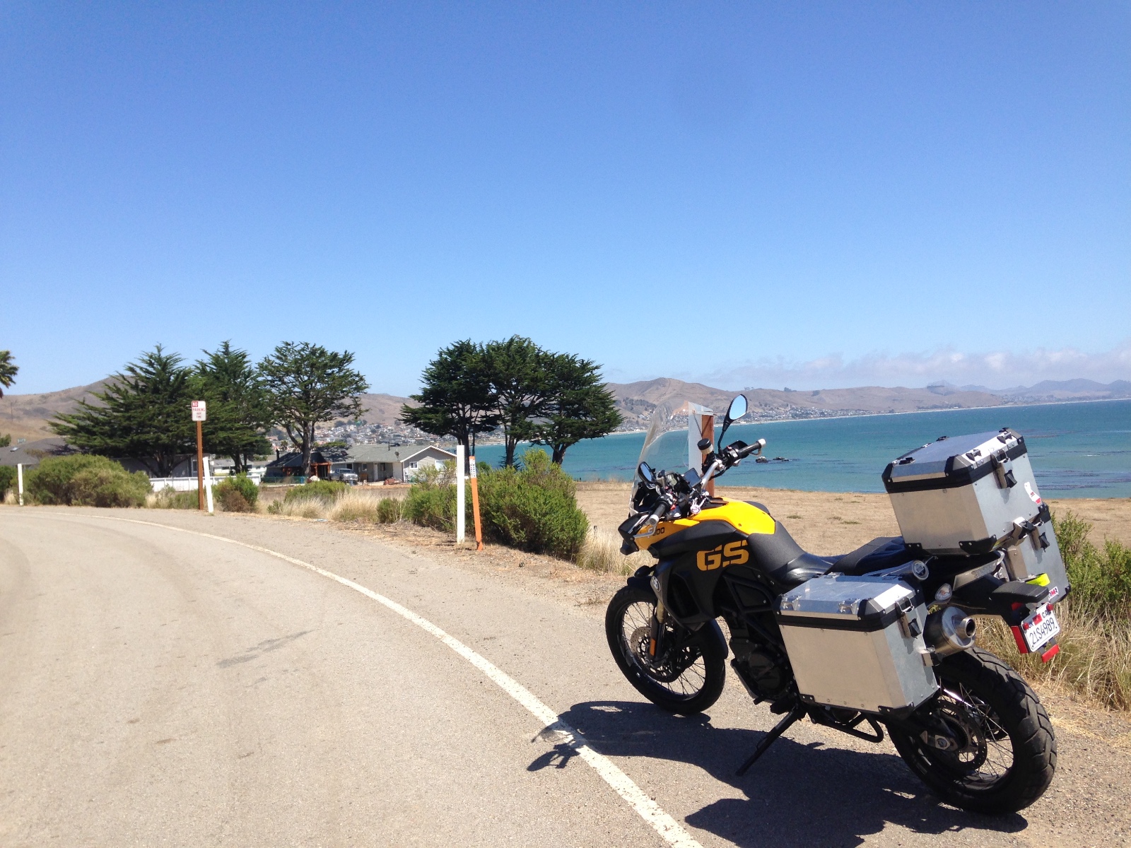 The motorcycle on the shoulder of Highway 1 above the bay