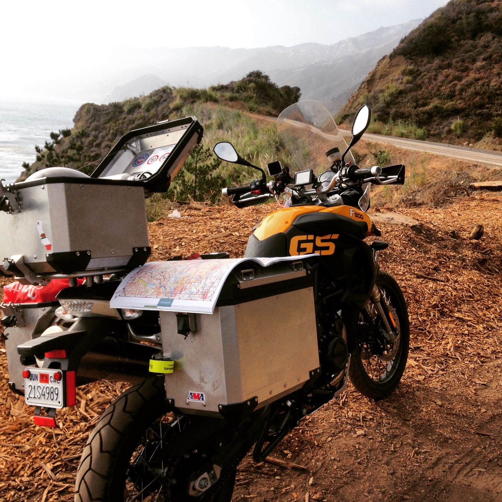 A paper map of California spread over the motorcycle pannier