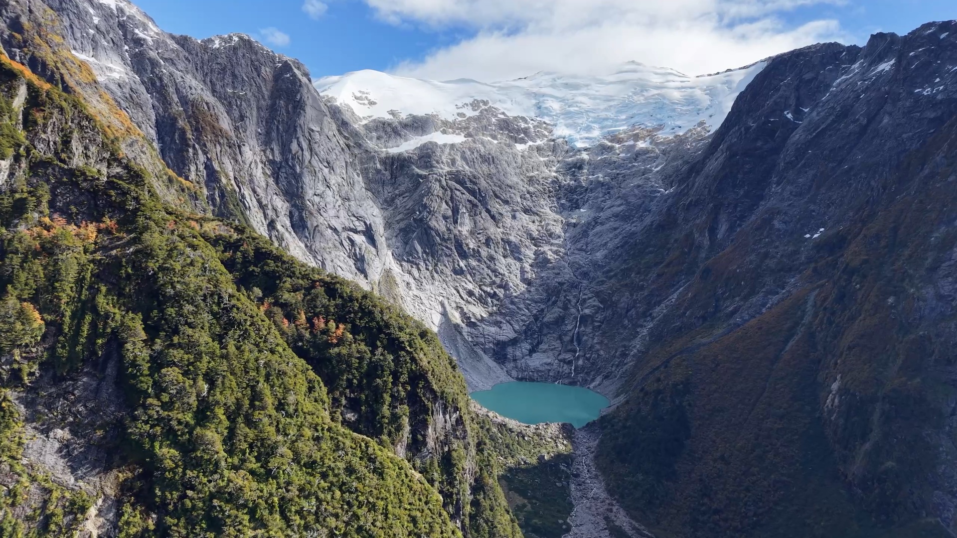A hanging glacier above a turquoise lagoon in Patagonia