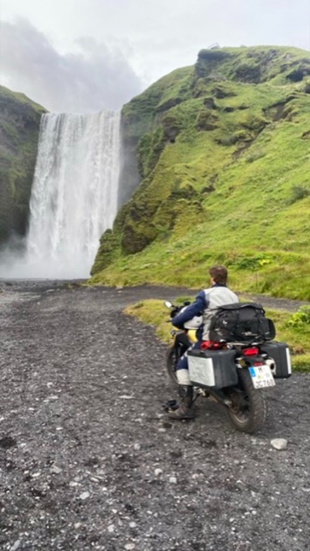 The bike parked in front of the Skogafoss waterfall