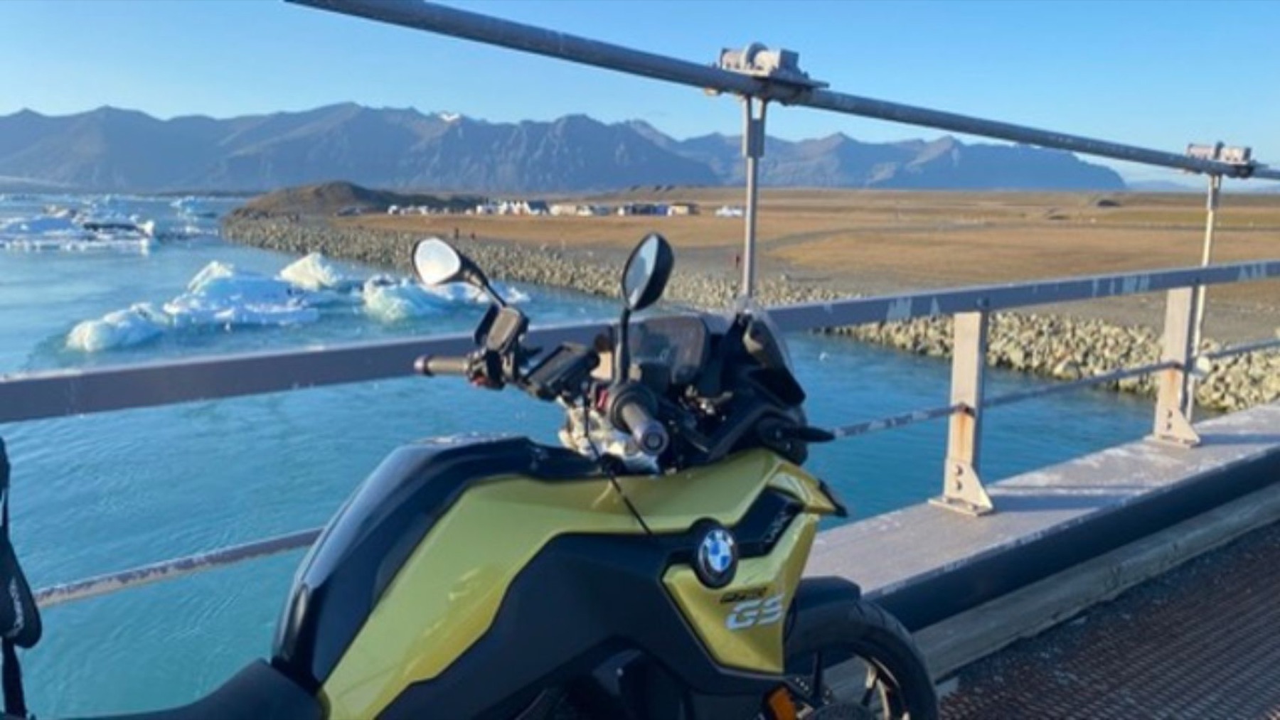 The bike on a bridge above a lagoon full of icebergs