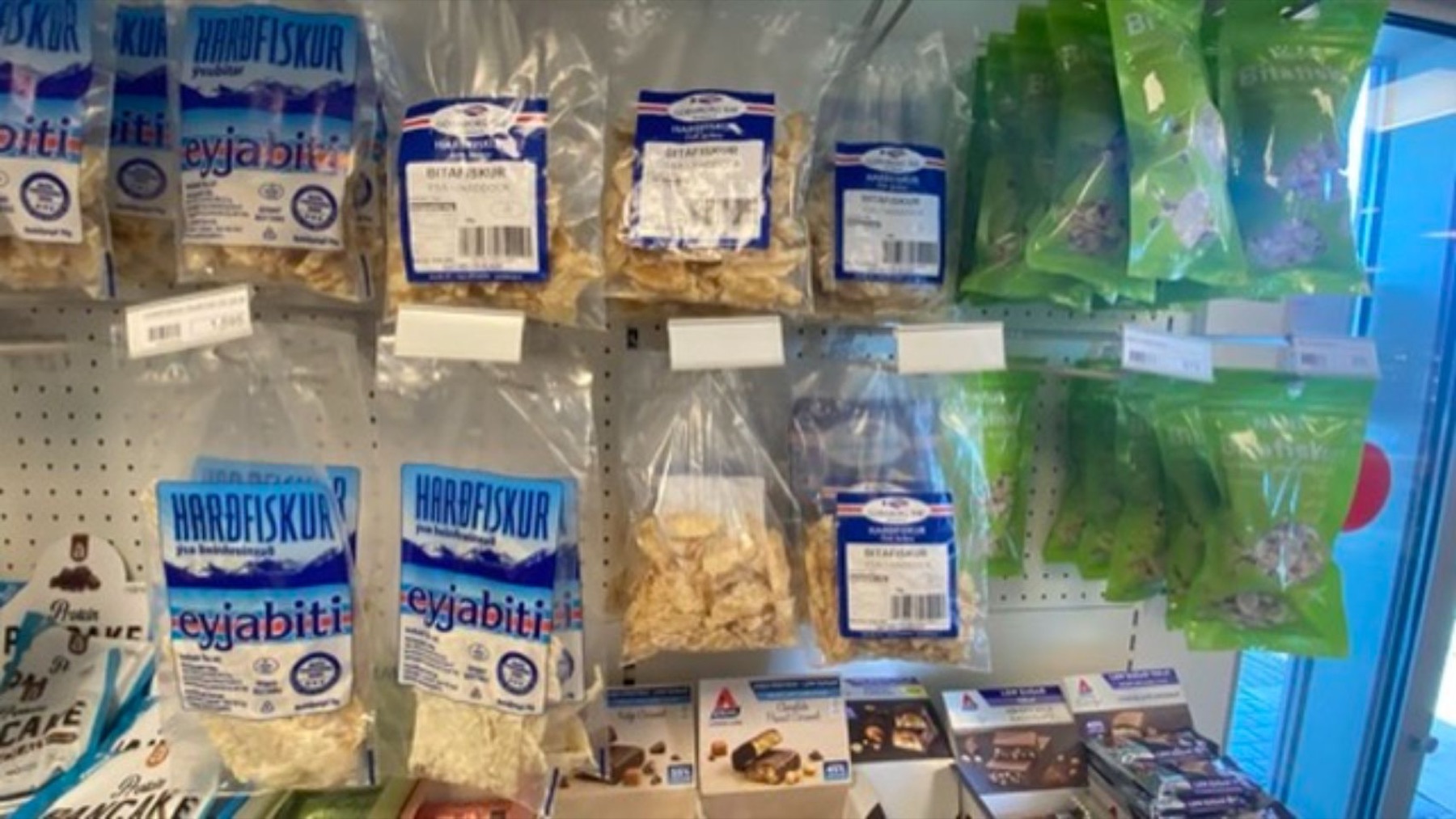 Packets of dried fish on a supermarket shelf