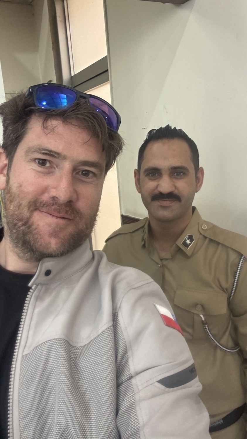 Rodrigo with a moustached officer in khaki uniform at the border