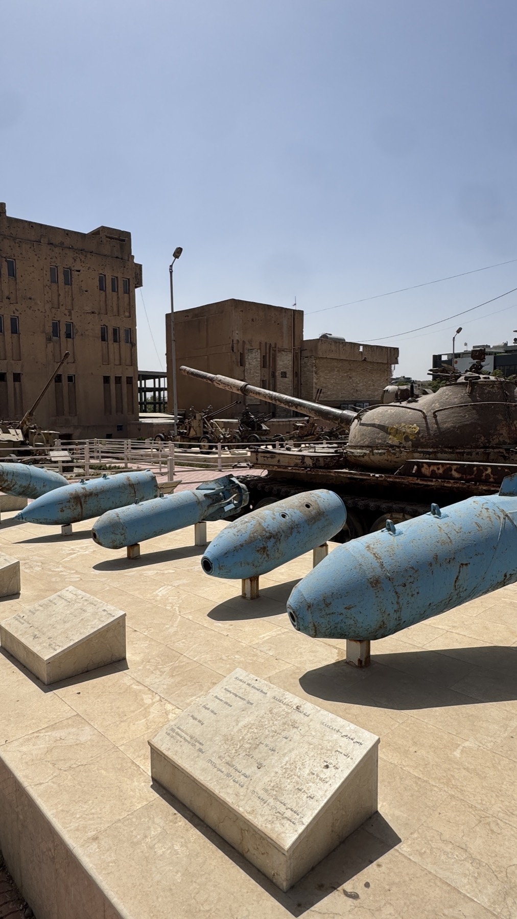 Artillery shells and a tank in the yard of the Amna Suraka museum