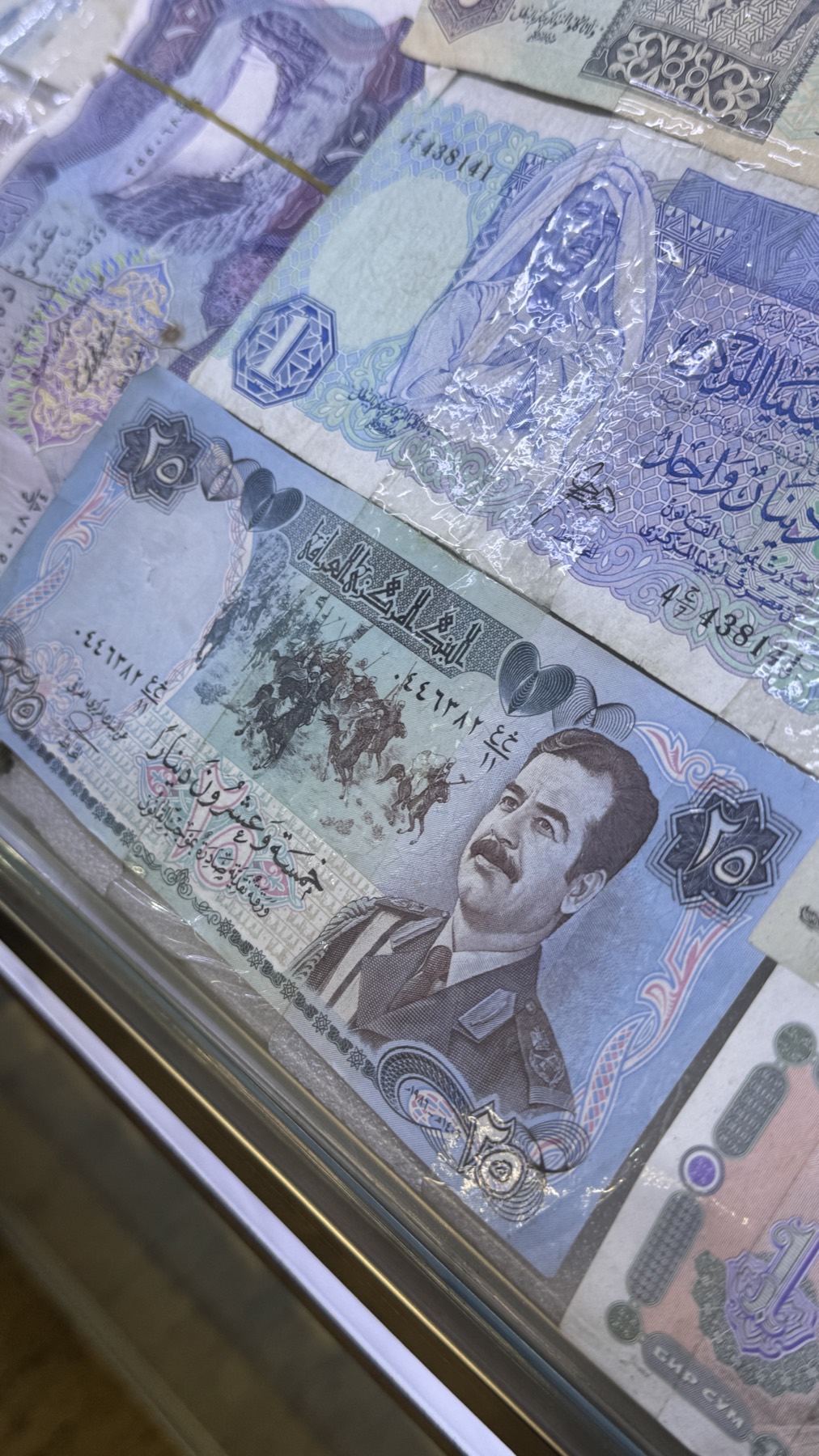 Old Iraqi banknotes bearing Saddam Hussein's portrait