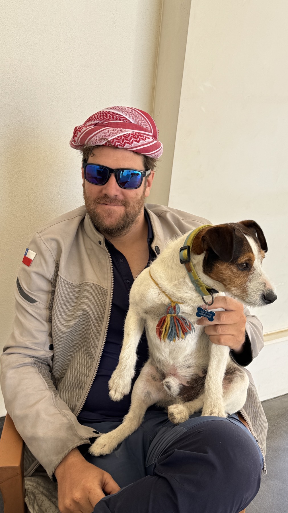 Rodrigo wearing a Kurdish headscarf, holding Jacko