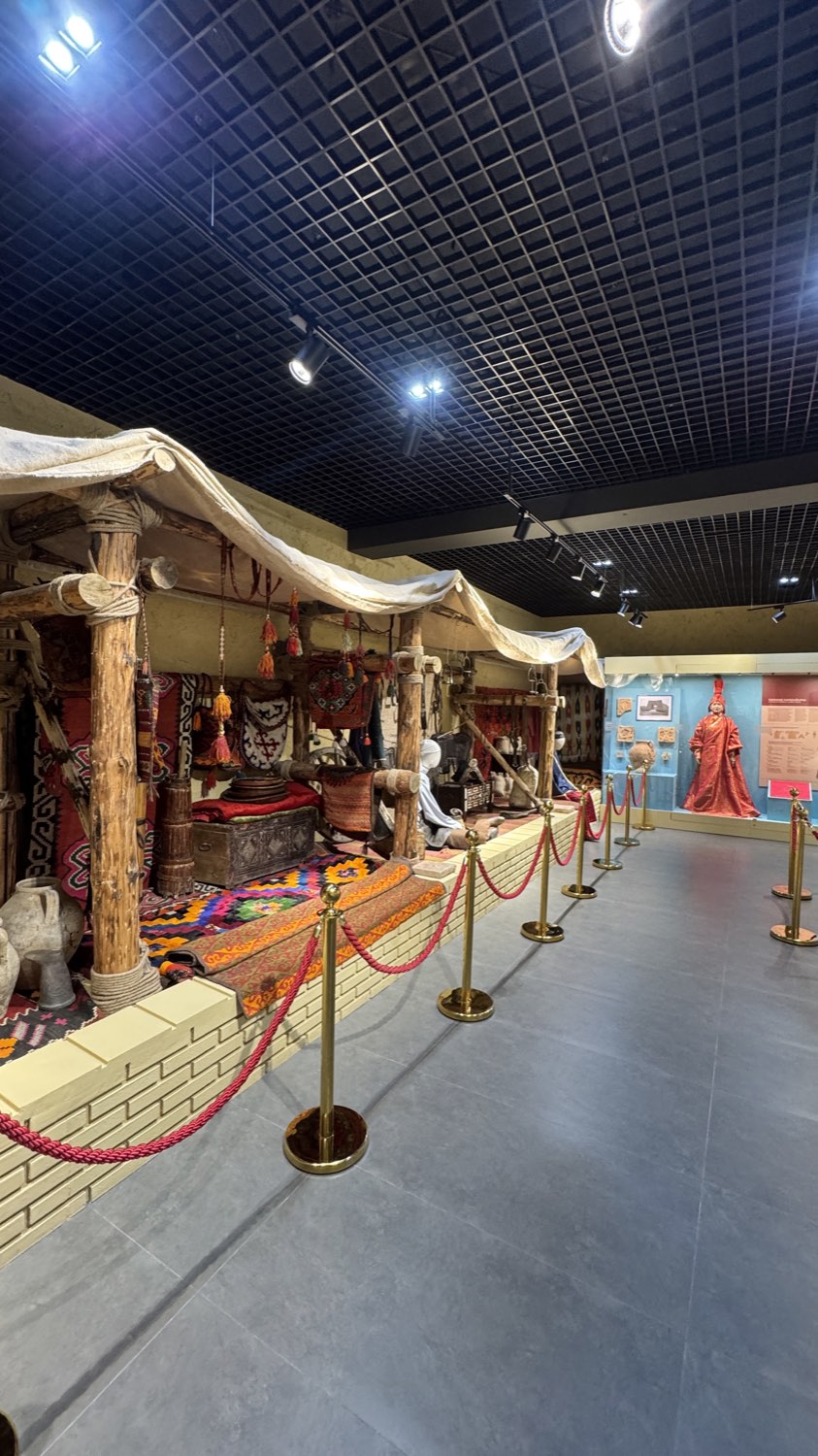 A long museum hall lined with mannequins in Kazakh costume