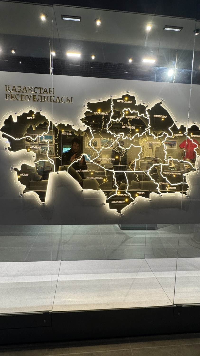 An illuminated relief map of Kazakhstan on a museum wall