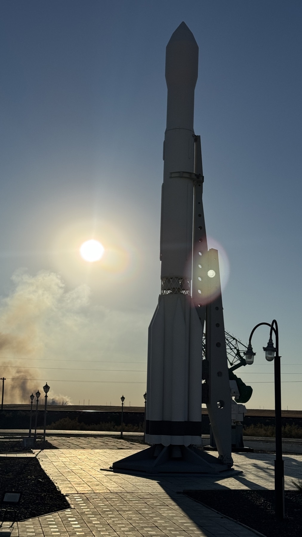A rocket standing against the sun at Baikonur