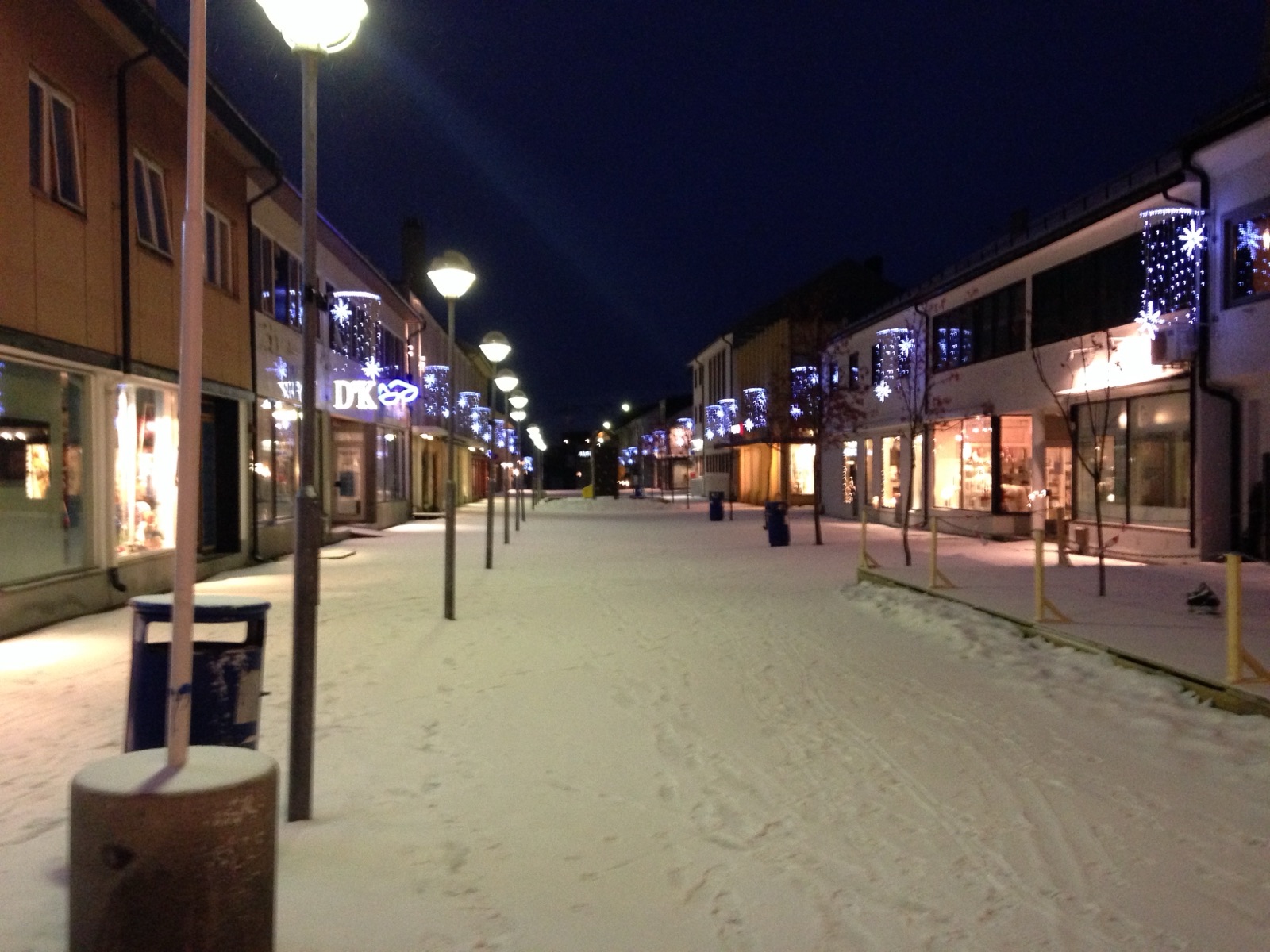 The main street of Kirkenes at night with blue Christmas lights
