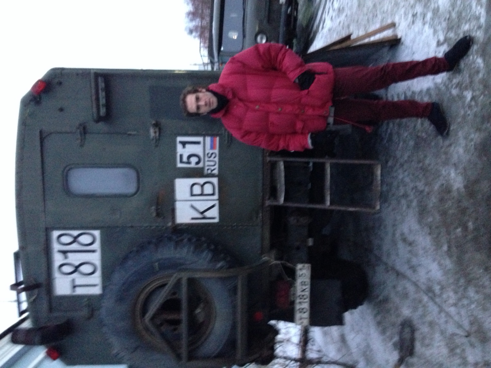 Rodrigo in a red snowsuit beside a Soviet military truck
