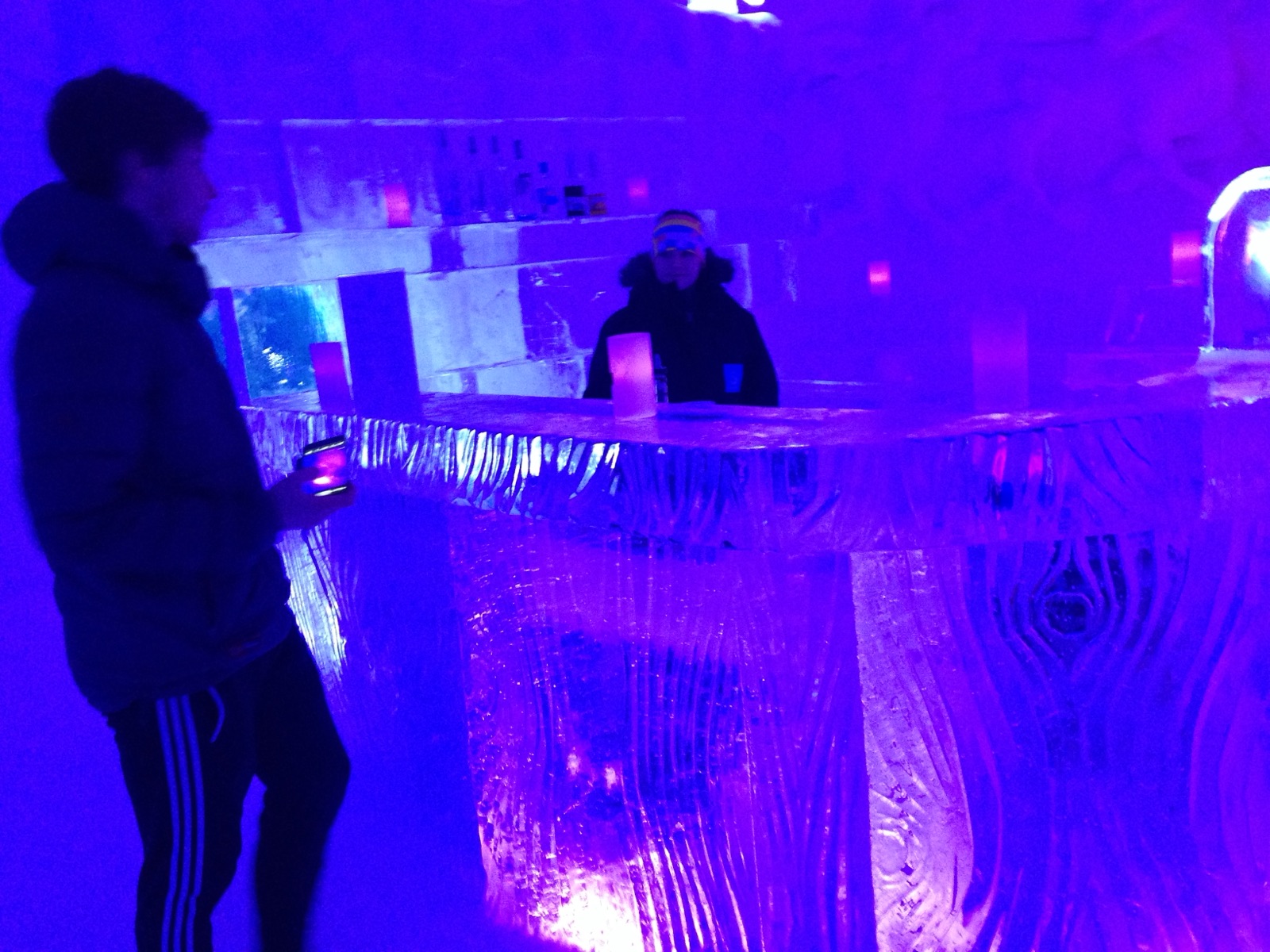The ice bar at the Snowhotel lit violet