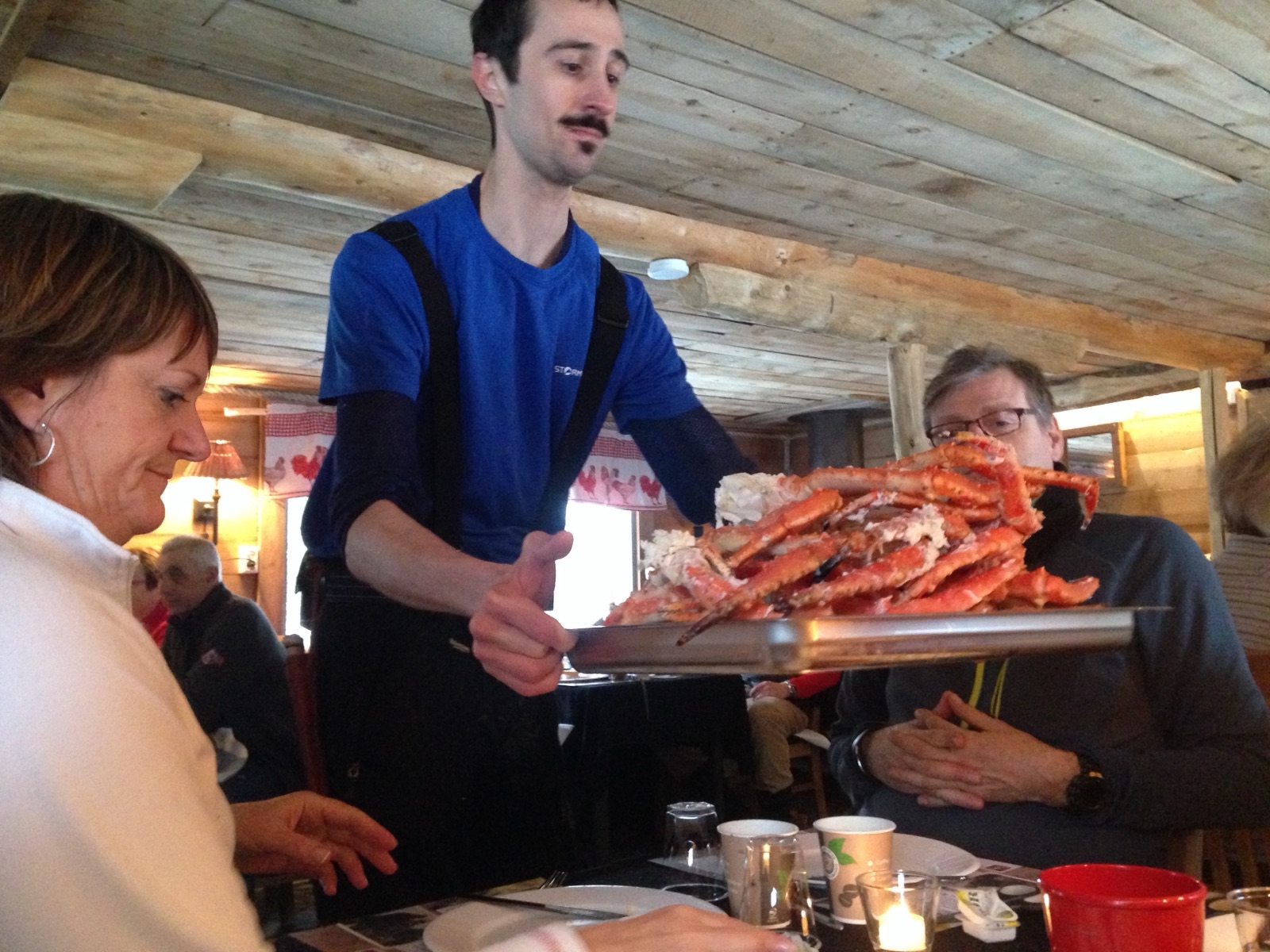 A tray of king crab served in a wooden cabin