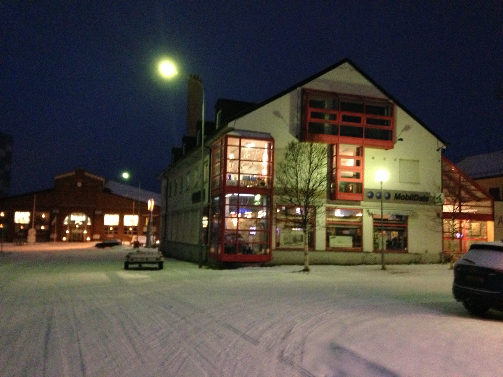 A lit building in Kirkenes in the blue midday dark