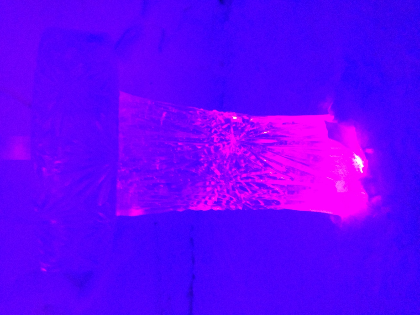 A block of ice lit pink