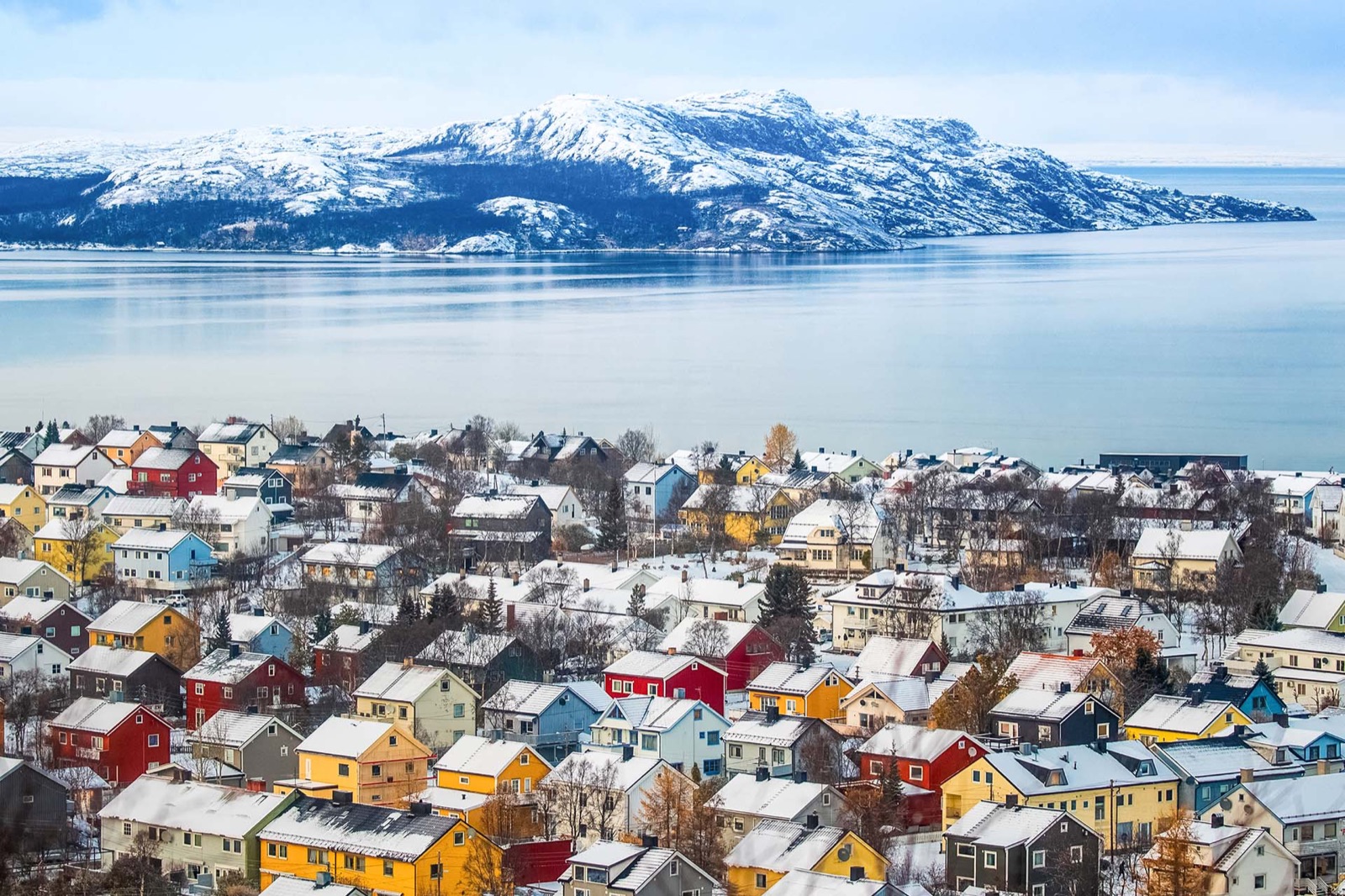 Kirkenes seen from above in winter, timber houses under snow