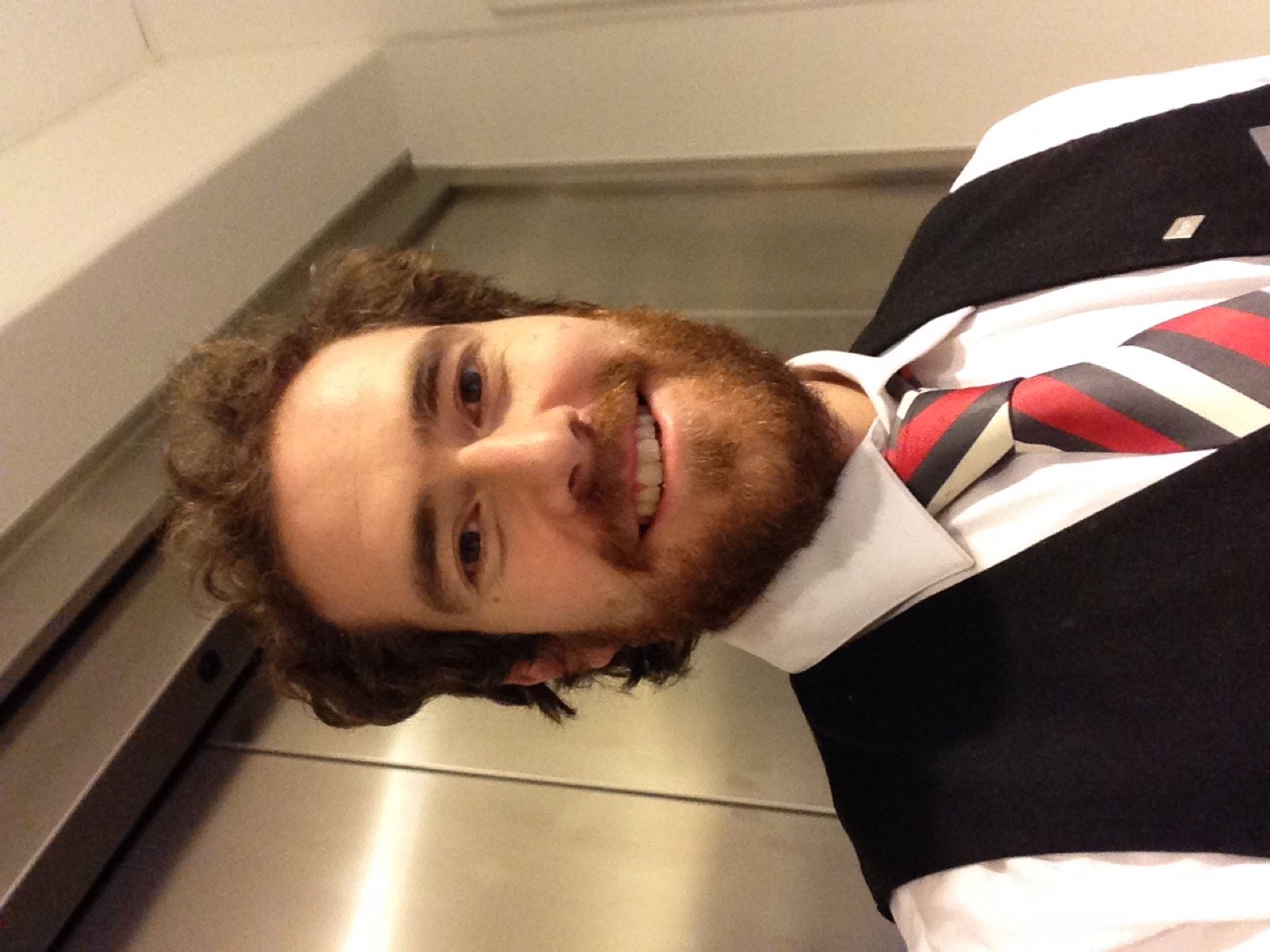 Rodrigo in waistcoat and striped tie behind the bar