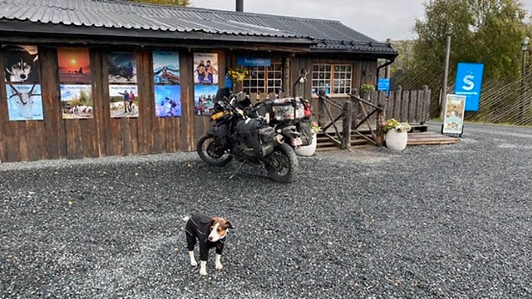 The loaded motorcycle and Jacko outside a roadside building in Arctic Norway