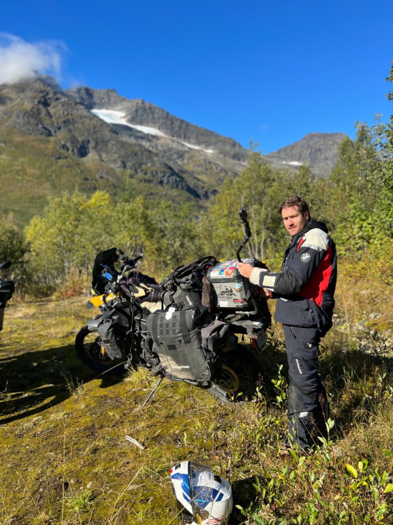 The motorcycle on a mountain pass with patches of snow