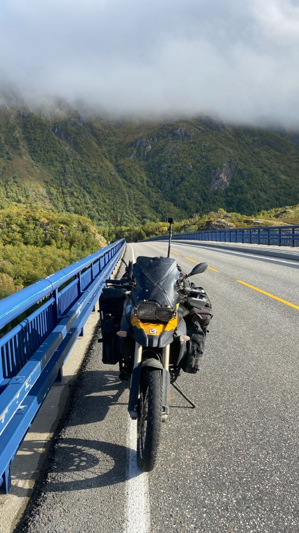 The motorcycle on a road cut into a steep mountainside