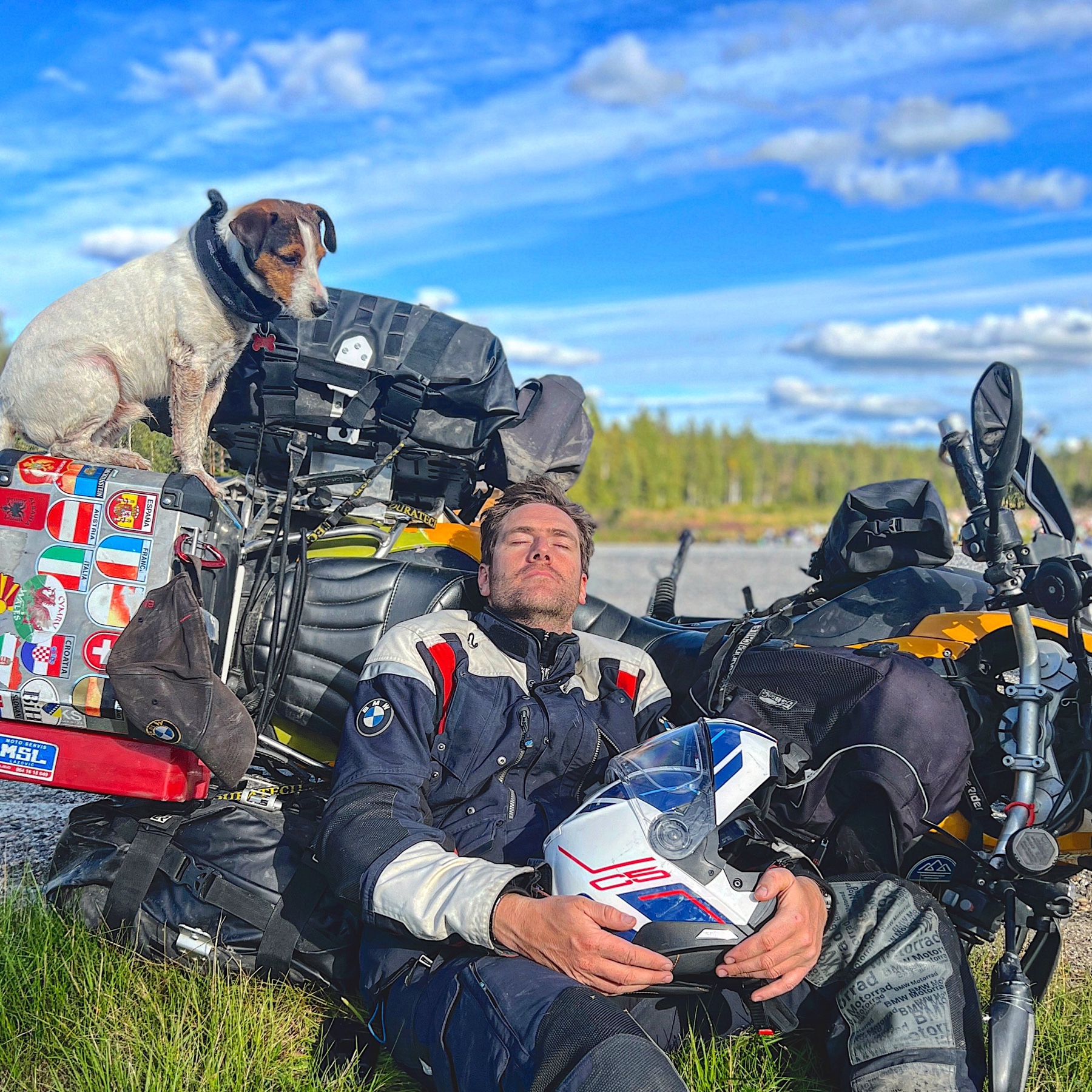 Rodrigo resting against his loaded motorcycle with Jacko sitting on the luggage