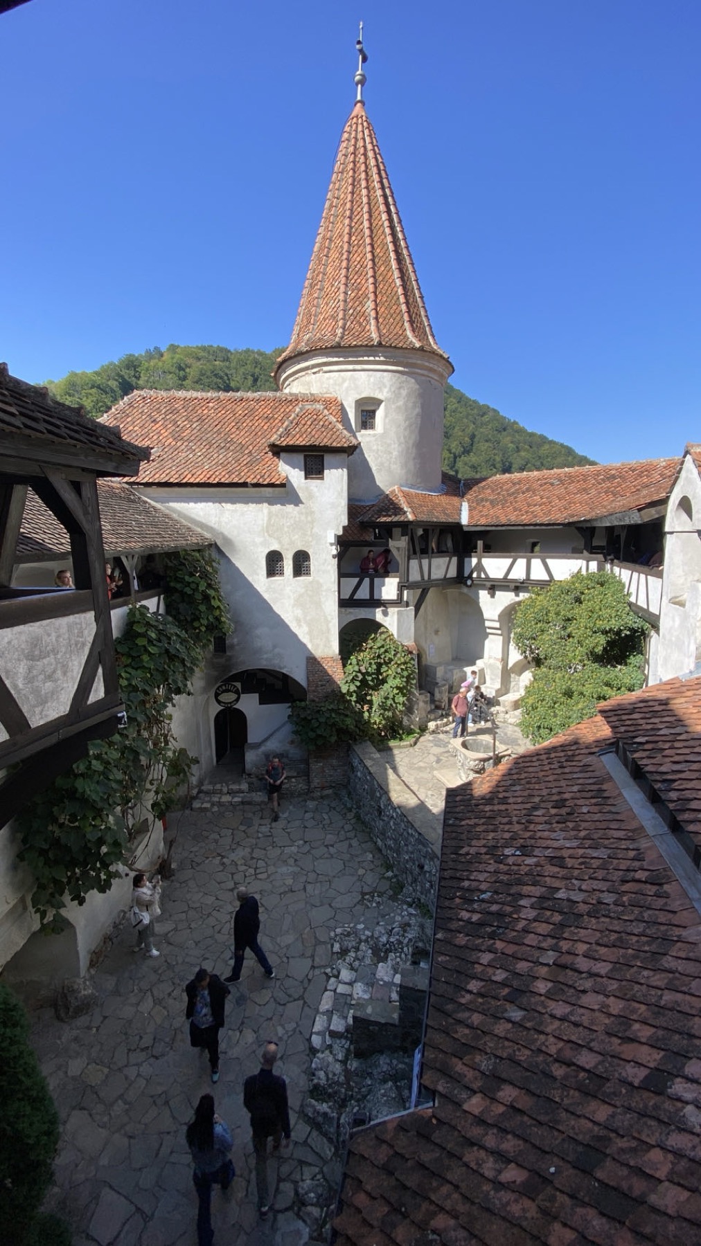 The courtyard of Bran castle with its red tiled roofs and tower