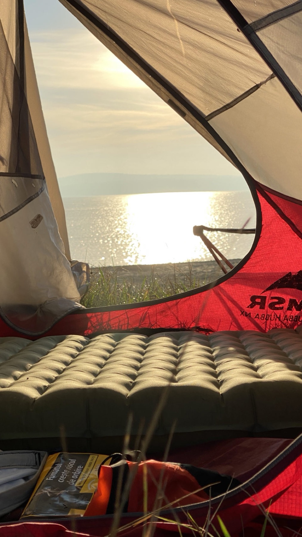 Sunrise over the reservoir seen from inside the tent