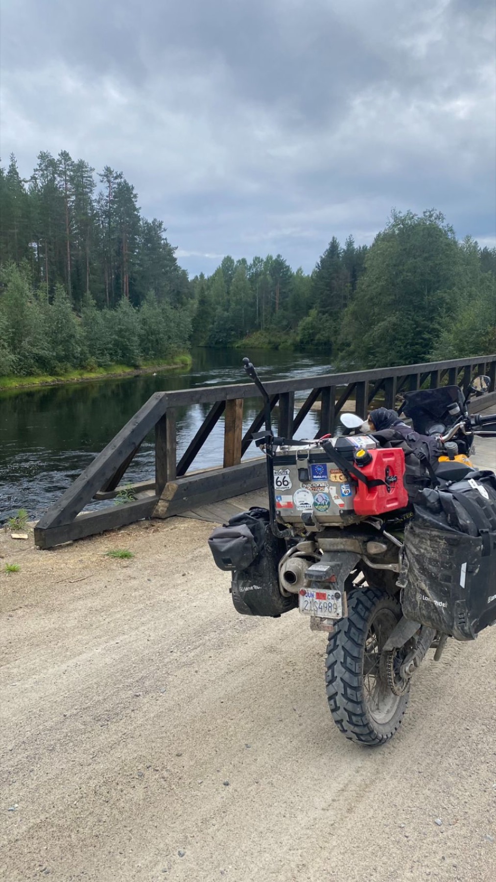 The motorcycle crossing a wooden bridge