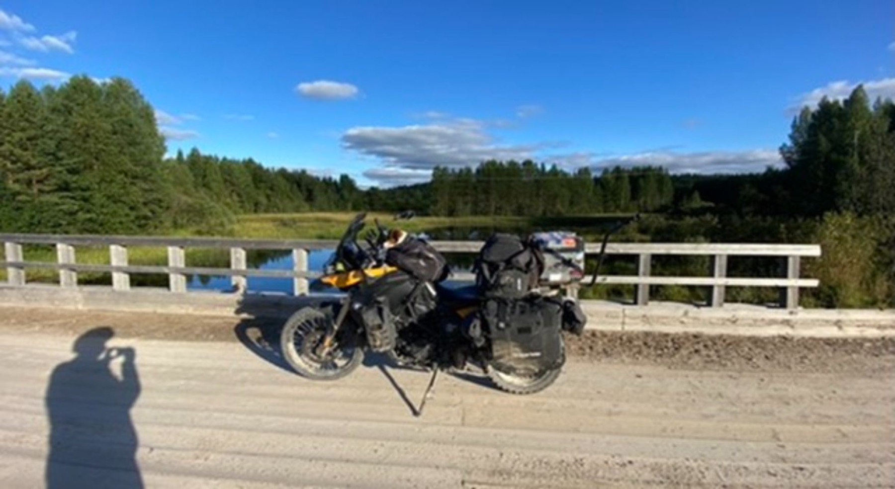 The motorcycle on a bridge over a river
