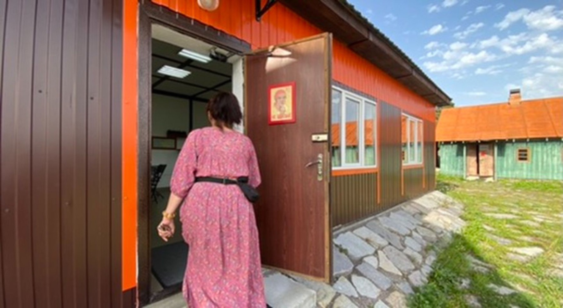A woman at the door of a village building