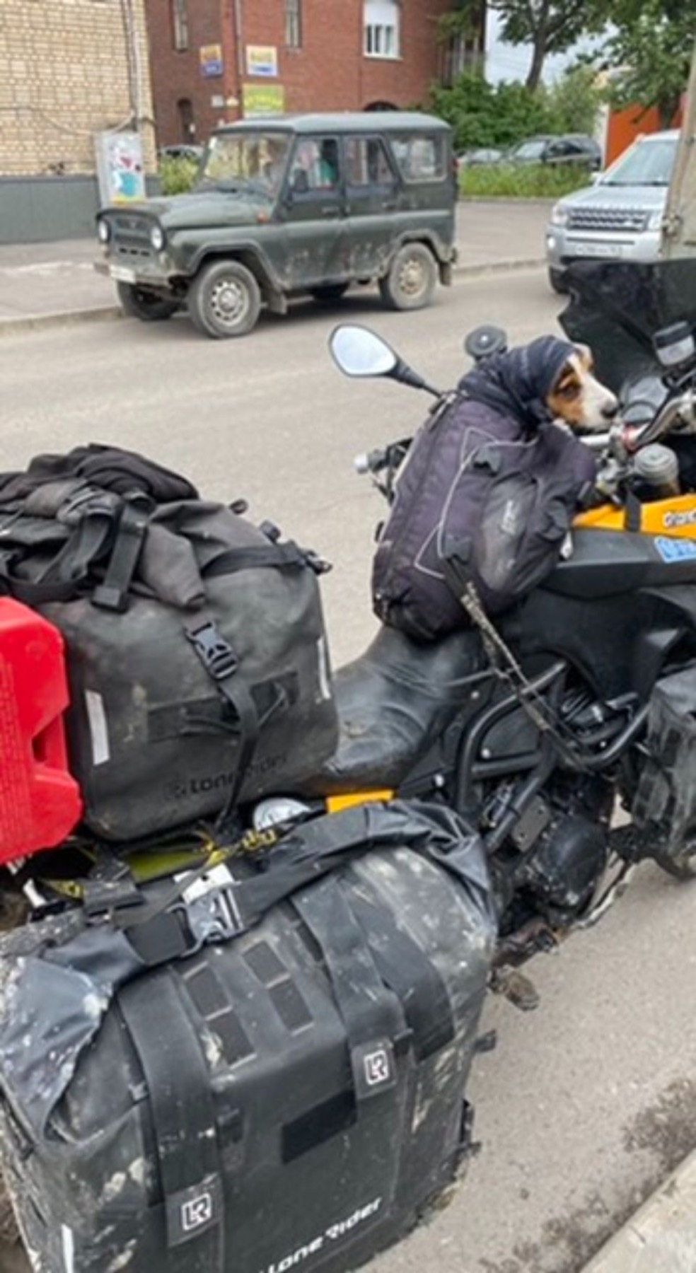 Two loaded motorcycles parked at the roadside