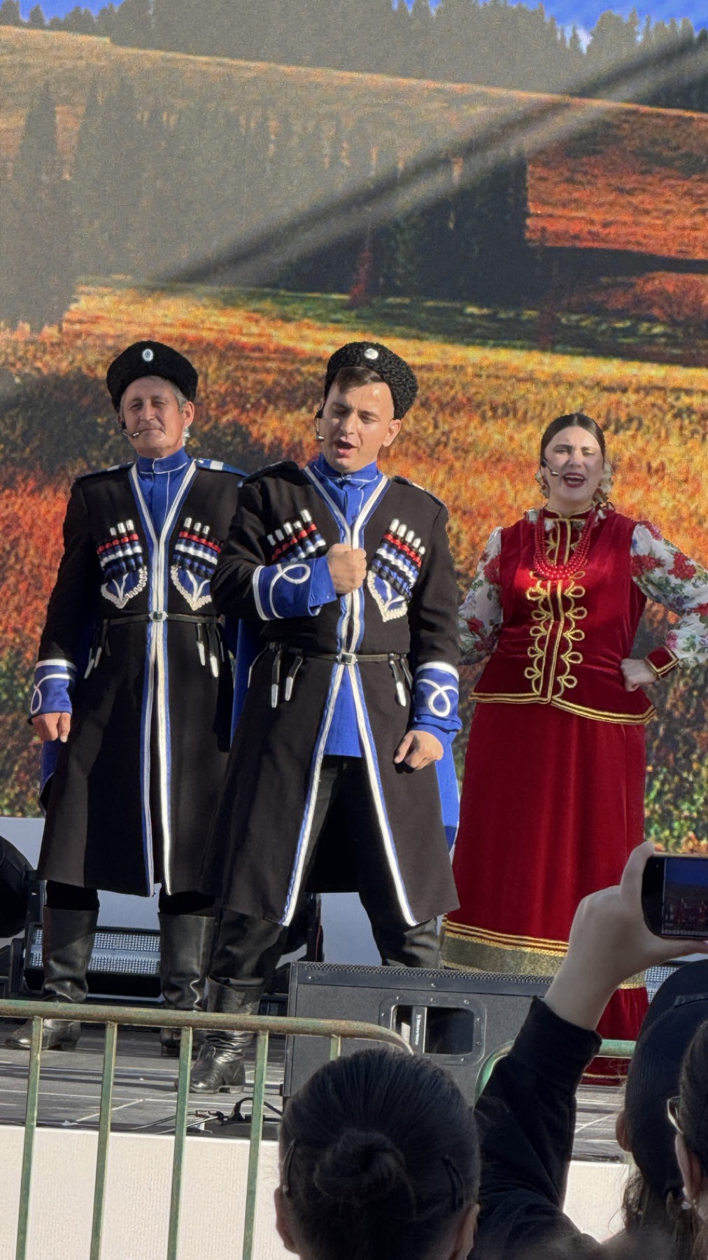 Singers in Cossack dress performing on a stage
