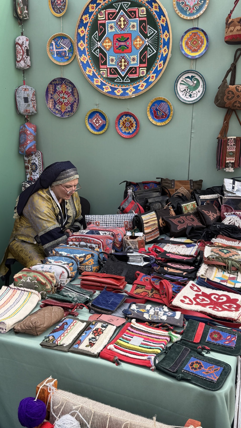 A stand of embroidered bags and beadwork
