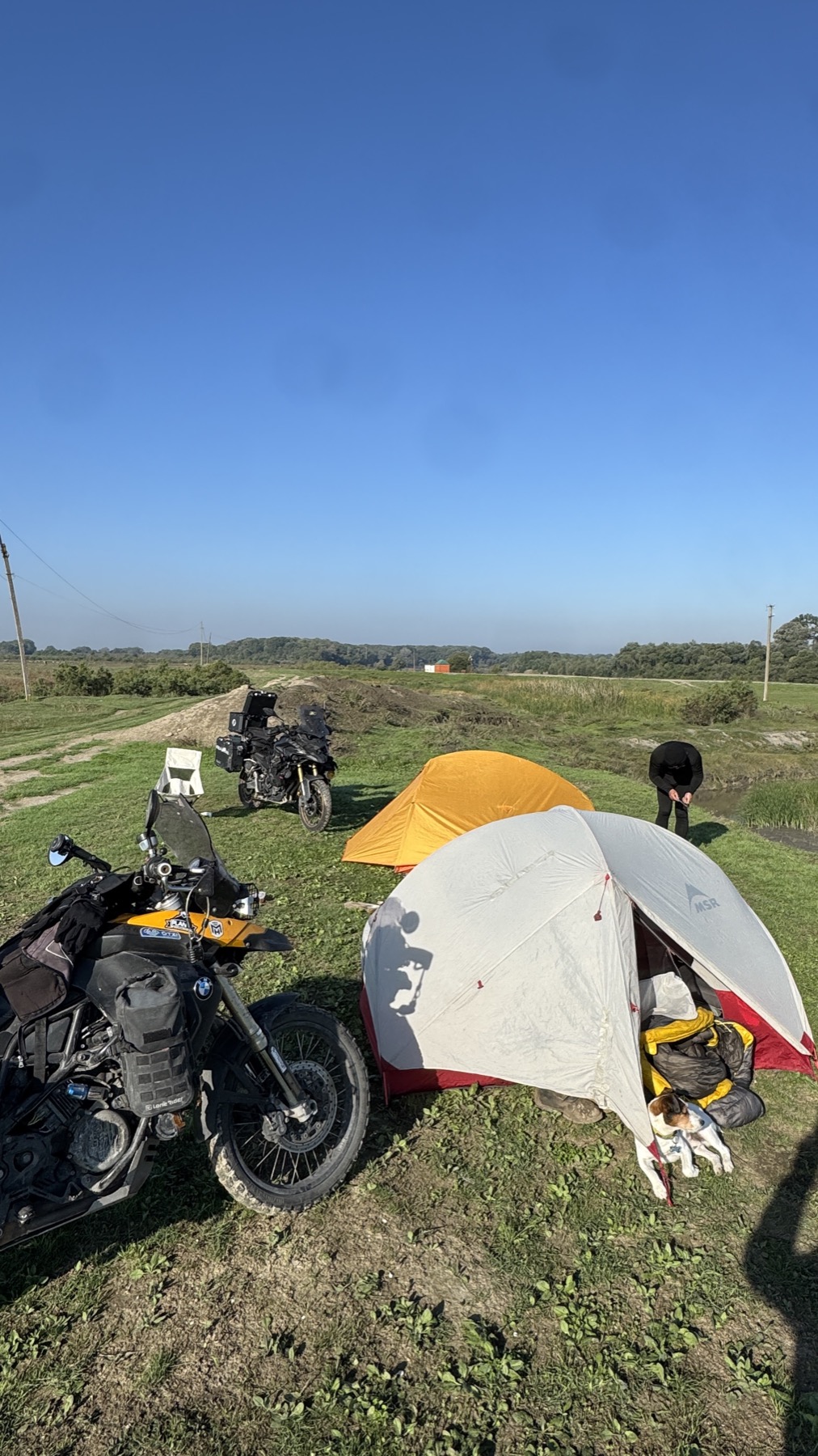 Two tents and two motorcycles pitched in a field in Chechnya