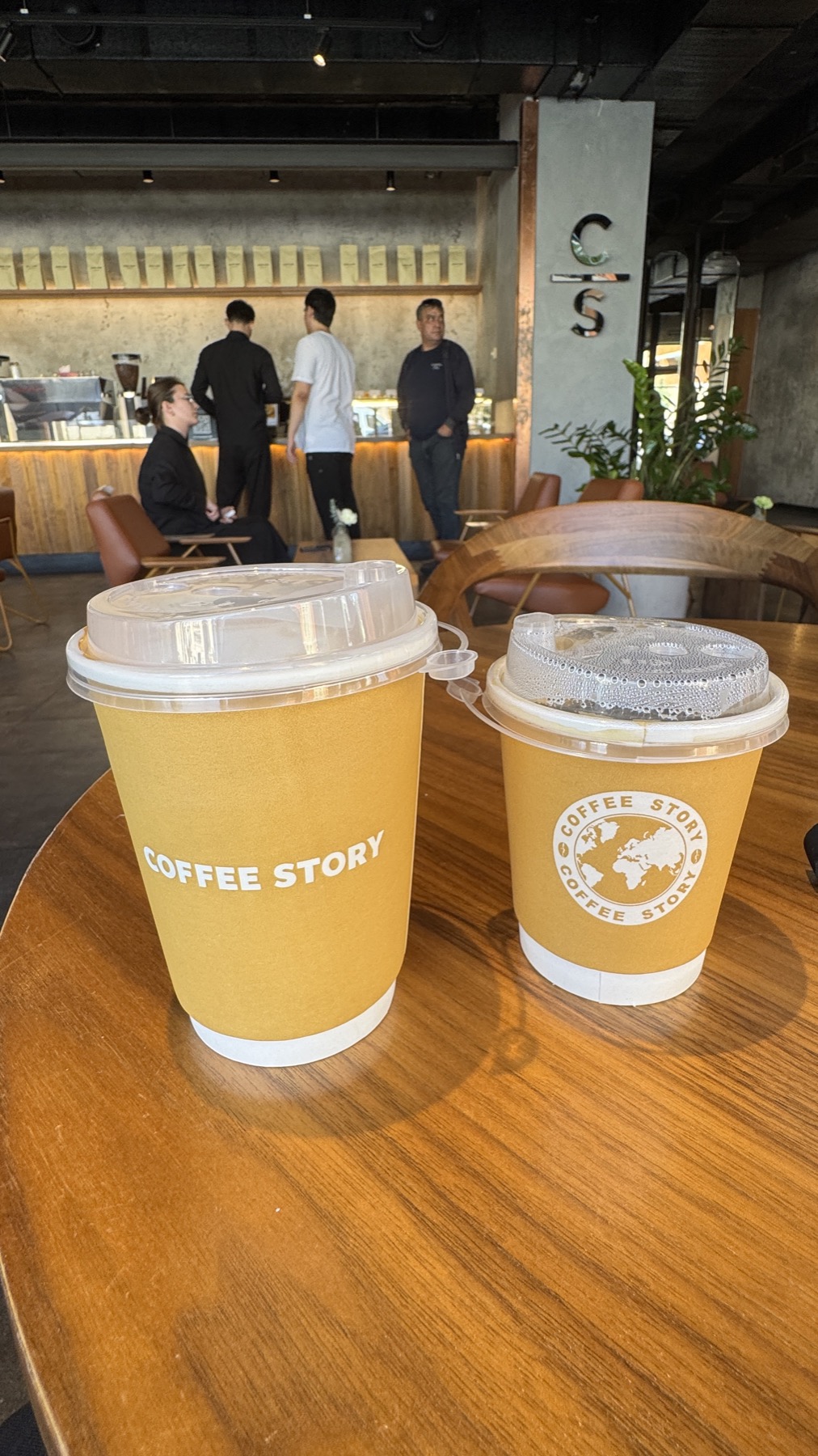 Two takeaway coffee cups on a table in a modern cafe in Grozny