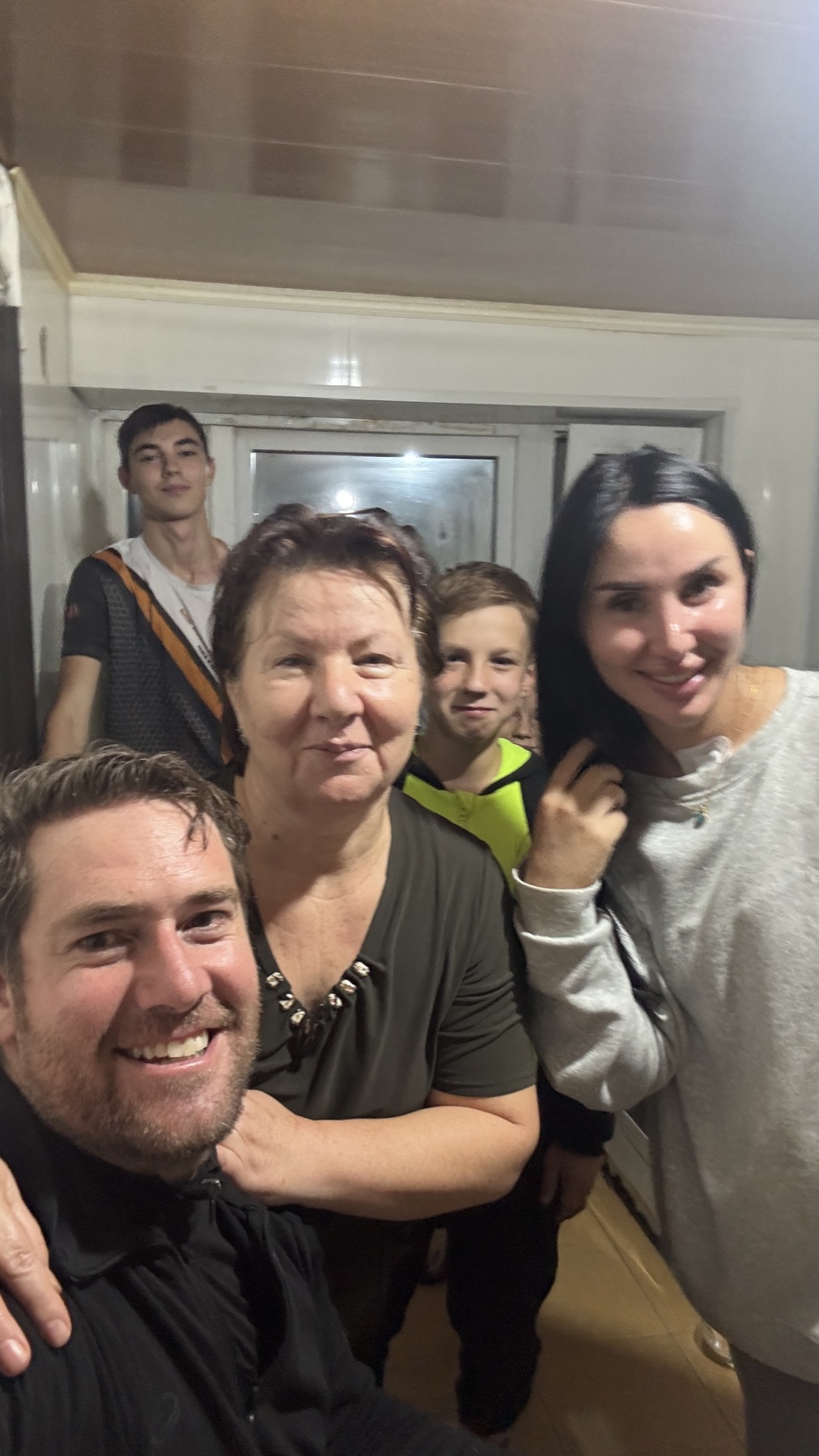 Rodrigo with the family who took him in at their house in Kizlyar, at night