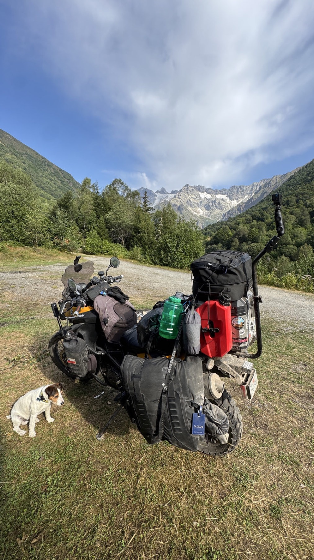 The loaded motorcycle with kit spread out on the grass