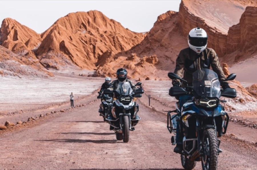 Riders on a desert road in the Atacama