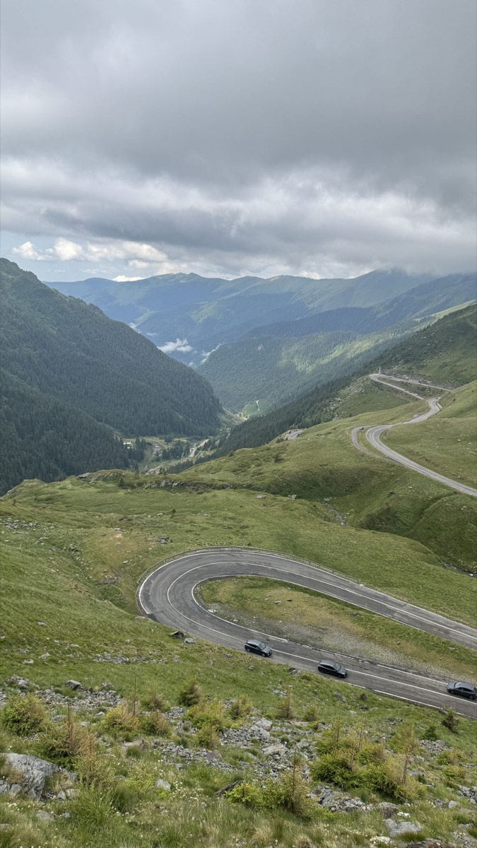 The Transfagarasan switchbacking down a green valley under low cloud